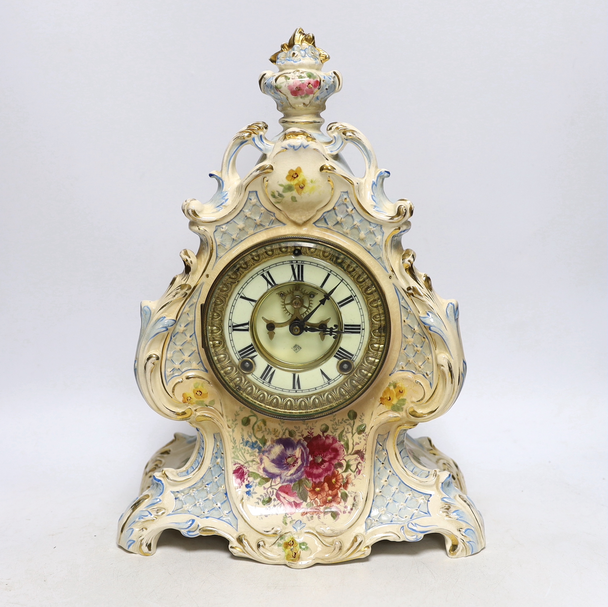A Royal Bonn pottery mantel clock with Ansonia movement, striking on a coiled gong, 37cm high